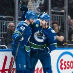Apr 14, 2026; Vancouver, British Columbia, CAN; Vancouver Canucks forward Elias Pettersson (40) and forward Jake DeBrusk (74) celebrate DeBrusk's game winning overtime goal at Rogers Arena.