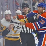 Oct 25, 2024; Edmonton, Alberta, CAN; Edmonton Oilers defensemen Darnell Nurse (25) fights Pittsburgh Penguins defensemen Marcus Pettersson (28) during the third period at Rogers Place.