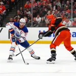 Apr 30, 2026; Anaheim, California, USA; Edmonton Oilers center Connor McDavid (97) and Anaheim Ducks defenseman Radko Gudas (7) battle for the puck in the first period of game six of the first round of the 2026 Stanley Cup Playoffs at Honda Center.