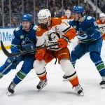 Mar 24, 2026; Vancouver, British Columbia, CAN; Vancouver Canucks forward Linus Karlsson (94) and forward Drew O'Connor (18) battle with Anaheim Ducks defenseman Radko Gudas (7) in the second period at Rogers Arena.