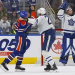 Feb 3, 2026; Edmonton, Alberta, CAN; Edmonton Oilers defensemen Darnell Nurse (25) and Toronto Maple Leafs defensemen Brandon Carlo (25) fight during the second period at Rogers Place.