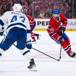 Apr 26, 2026; Montreal, Quebec, CAN; Montreal Canadiens defenseman Alexandre Carrier (45) plays the puck against Tampa Bay Lightning defenseman Darren Raddysh (43) during the third period in game four of the first round of the 2026 Stanley Cup Playoffs at Bell Centre. Mandatory Credit: David Kirouac-Imagn Images
