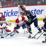 Feb 4, 2026; Winnipeg, Manitoba, CAN; Winnipeg Jets left wing Kyle Connor (81) and Montreal Canadiens center Phillip Danault (24) dig for the puck in front of goaltender Samuel Montembeault (35) during the third period at Canada Life Centre.