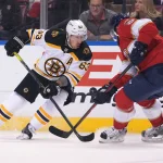 Oct 27, 2021; Sunrise, Florida, USA; Boston Bruins center Brad Marchand (63) battles Florida Panthers defenseman Radko Gudas (7) for the puck during the first period at FLA Live Arena.