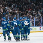 Apr 14, 2026; Vancouver, British Columbia, CAN; Vancouver Canucks defenseman Tom Willander (5) and defenseman Filip Hronek (17) and forward Ty Mueller (39) and forward Jake DeBrusk (74) and forward Elias Pettersson (40) and goalie Kevin Lankinen (32) celebrate their victory against the Los Angeles Kings in overtime at Rogers Arena.
