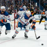 Jan 17, 2026; Vancouver, British Columbia, CAN; Edmonton Oilers defenseman Darnell Nurse (25) watches as defenseman Ty Emberson (49) handles the puck against the Vancouver Canucks in the second period at Rogers Arena.