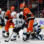 Dec 3, 2025; Anaheim, California, USA; Utah Mammoth defeseman Sean Durzi (50) and defenseman Nate Schmidt (88) help goaltender Karel Vejmelka (70) defend the goal against Anaheim Ducks center Mason McTavish (23) and left wing Cutter Gauthier (61) during the first period at Honda Center.