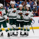 Mar 8, 2026; Denver, Colorado, USA; Minnesota Wild left wing Kirill Kaprizov (97) celebrates his goal with left wing Matt Boldy (12) and center Joel Eriksson Ek (14) and defenseman Quinn Hughes (43) in the third period against the Colorado Avalanche at Ball Arena.