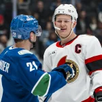 Mar 9, 2026; Vancouver, British Columbia, CAN; Ottawa Senators forward Brady Tkachuk (7) talks with Vancouver Canucks forward Nils Hoglander (21) during a stop in play in the second period at Rogers Arena: