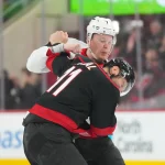 Apr 18, 2026; Raleigh, North Carolina, USA; Ottawa Senators left wing Brady Tkachuk (7) and Carolina Hurricanes center Jordan Staal (11) fight during the first period in game one of the first round of the 2026 Stanley Cup Playoffs at Lenovo Center.