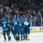 Apr 14, 2026; Vancouver, British Columbia, CAN; Vancouver Canucks defenseman Tom Willander (5) and defenseman Filip Hronek (17) and forward Ty Mueller (39) and forward Jake DeBrusk (74) and forward Elias Pettersson (40) and goalie Kevin Lankinen (32) celebrate their victory against the Los Angeles Kings in overtime at Rogers Arena.