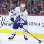Jan 8, 2026; Philadelphia, Pennsylvania, USA; Toronto Maple Leafs defenseman Morgan Rielly (44) controls the puck against the Philadelphia Flyers during the first period at Xfinity Mobile Arena.