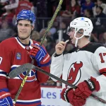 Sep 24, 2024; Montreal, Quebec, CAN; Montreal Canadiens forward Juraj Slafkovsky (20) and New Jersey Devils defenseman Simon Nemec (17) exchange words before a faceoff during the third period at the Bell Centre. Mandatory Credit: Eric Bolte-Imagn Images
