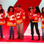 Dec 3, 2024; Calgary, Alberta, CAN; Johnny Gaudreau's family during ceremonial puck drop by Columbus Blue Jackets center Sean Monahan (23) and Calgary Flames center Mikael Backlund (11) prior to the game between the Calgary Flames and the Columbus Blue Jackets at Scotiabank Saddledome.