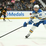 Mar 21, 2026; Vancouver, British Columbia, CAN; St. Louis Blues right wing Jordan Kyrou (25) reaches for the puck during the third period against the Vancouver Canucks at Rogers Arena.
