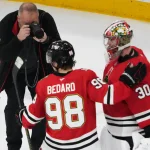 Apr 15, 2026; Chicago, Illinois, USA; Chicago Blackhawks goaltender Spencer Knight (30) center Connor Bedard (98) celebrate their win against the San Jose Sharks at United Center.
