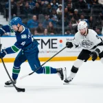 Apr 14, 2026; Vancouver, British Columbia, CAN; Los Angeles Kings forward Adrian Kempe (9) stick checks Vancouver Canucks forward Elias Pettersson (40) while shooting in the third period at Rogers Arena.