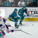 Apr 8, 2026; San Jose, California, USA; San Jose Sharks center Macklin Celebrini (71), center Will Smith (2), Edmonton Oilers center Connor McDavid (97) and center Matthew Savoie (22) chase the puck in the third period at SAP Center at San Jose.