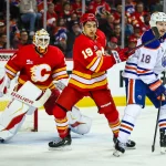 Feb 4, 2026; Calgary, Alberta, CAN; Calgary Flames defenseman Zayne Parekh (19) and Edmonton Oilers left wing Zach Hyman (18) fight for position in front of Calgary Flames goaltender Devin Cooley (1) during the third period at Scotiabank Saddledome. Mandatory Credit: Sergei Belski-Imagn Images