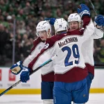 Mar 6, 2026; Dallas, Texas, USA; Colorado Avalanche defenseman Cale Makar (8) and center Nathan MacKinnon (29) and right wing Valeri Nichushkin (13) celebrate a goal during the game between the Stars and the Avalanche at American Airlines Center.