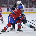 Oct 14, 2025; Montreal, Quebec, CAN; Montreal Canadiens defenseman Mike Matheson (8) seperates Seattle Kraken forward Matty Beniers (10) from the puck during the first period at the Bell Centre. Mandatory Credit: Eric Bolte-Imagn Images