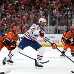 Apr 24, 2026; Anaheim, California, USA; Edmonton Oilers defenseman Darnell Nurse (25) shoots the puck ahead of Anaheim Ducks center Mason McTavish (23) during the first period of game three of the first round of the 2026 Stanley Cup Playoffs at Honda Center.