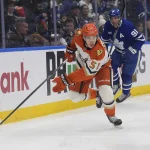 Mar 12, 2026; Toronto, Ontario, CAN; Anaheim Ducks defenseman Olen Zellweger (51) carries the puck past Toronto Maple Leafs forward John Tavares (91) during the first period at Scotiabank Arena.