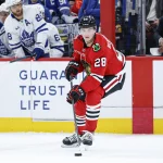 Nov 15, 2025; Chicago, Illinois, USA; Chicago Blackhawks left wing Andre Burakovsky (28) looks to pass the puck against the Toronto Maple Leafs during the first period at United Center.