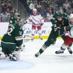 Mar 13, 2025; Saint Paul, Minnesota, USA; Minnesota Wild defenseman Zach Bogosian (24) and New York Rangers left wing Brett Berard (65) compete for the puck during the first period at Xcel Energy Center.