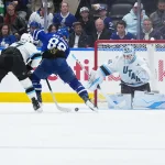Nov 5, 2025; Toronto, Ontario, CAN; Toronto Maple Leafs right wing William Nylander (88) battles for the puck with Utah Mammoth right wing JJ Peterka (77) during the second period at Scotiabank Arena.