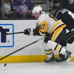 February 26, 2020; Los Angeles, California, USA; Pittsburgh Penguins center Sidney Crosby (87) plays for the puck against Los Angeles Kings defenseman Drew Doughty (8) during the first period at Staples Center.