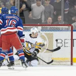 Mar 16, 2023; New York, New York, USA; New York Rangers left wing Chris Kreider (not pictured) scores an empty net goal past Pittsburgh Penguins center Sidney Crosby (87) during the third period in front of center Vincent Trocheck (16) at Madison Square Garden.