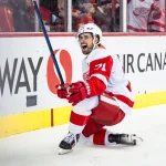 Feb 1, 2025; Calgary, Alberta, CAN; Detroit Red Wings center Dylan Larkin (71) celebrates after scoring a goal against the Calgary Flames during the first period at Scotiabank Saddledome.