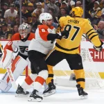 Apr 18, 2026; Pittsburgh, Pennsylvania, USA; Philadelphia Flyers defenseman Cam York (8) checks Pittsburgh Penguins center Sidney Crosby (87) in front of Flyers goaltender Dan Vladar (80) during the first period against in game one of the first round of the 2026 Stanley Cup Playoffs at PPG Paints Arena.