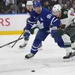 Jan 19, 2026; Toronto, Ontario, CAN; Toronto Maple Leafs forward John Tavares (91) vies for a loose puck against Minnesota Wild forward Vladimir Tarasenko (91) during the first period at Scotiabank Arena.