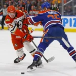 Jan 26, 2026; Edmonton, Alberta, CAN; Edmonton Oilers defensemen Darnell Nurse (25) knocks Anaheim Ducks forward Beckett Sennecke (45) off the puck during the second period at Rogers Place. Mandatory Credit: Perry Nelson-Imagn Images