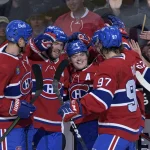 Sep 26, 2022; Montreal, Quebec, CAN; Montreal Canadiens forward Cole Caufield (22) celebrates with teammates including defenseman Mike Matheson (8) and forward Joshua Roy (97) after scoring a goal against the New Jersey Devils during the first period at the Bell Centre.