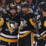 Oct 27, 2025; Pittsburgh, Pennsylvania, USA; Pittsburgh Penguins right wing Bryan Rust (17) celebrates his second goal of the game with defensemen Erik Karlsson (65) and Parker Wotherspoon (28) against the St. Louis Blues during the third period at PPG Paints Arena.