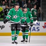 Jan 20, 2026; Dallas, Texas, USA; Dallas Stars left wing Jason Robertson (21) and center Mavrik Bourque (22) skate off the ice after scoring a goal against the Boston Bruins during the game at the American Airlines Center.