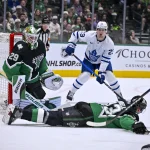 Dec 21, 2025; Dallas, Texas, USA; Dallas Stars defenseman Esa Lindell (23) blocks a pass from Toronto Maple Leafs left wing Nicholas Robertson (89) to left wing Matthew Knies (23) in front of goaltender Jake Oettinger (29) during the first period at the American Airlines Center.