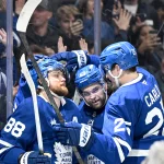 Mar 20, 2026; Toronto, Ontario, CAN; Toronto Maple Leafs forward William Nylander (88) celebrates with defenseman Brando Carlo (25) and forward Matias Maccelli (63) after scoring a goal against the Carolina Hurricanes in the third period at Scotiabank Arena.