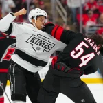 Feb 1, 2025; Raleigh, North Carolina, USA; Carolina Hurricanes left wing Juha Jaaska (54) fights Los Angeles Kings center Akil Thomas (26) during the first period at Lenovo Center.