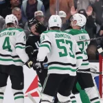 Dec 23, 2024; Salt Lake City, Utah, USA; Utah Hockey Club center Barrett Hayton (27) and Dallas Stars defenseman Esa Lindell (23) fight during the third period at Delta Center.