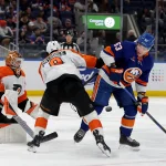Jan 24, 2025; Elmont, New York, USA; New York Islanders center Casey Cizikas (53) fights for the puck against Philadelphia Flyers defenseman Jamie Drysdale (9) in front of Flyers goaltender Ivan Fedotov (82) during the second period at UBS Arena.