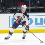 Jan 31, 2025; Salt Lake City, Utah, USA; Columbus Blue Jackets defenseman Zach Werenski (8) looks to shoot the puck against the Utah Hockey Club during the first period at Delta Center.