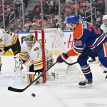 Dec 31, 2025; Edmonton, Alberta, CAN; Edmonton Oilers center Leon Draisaitl (29) plays the puck in front of Boston Bruins goalie Jeremy Swayman (1) and defenseman Nikita Zadorov (91) during the third period at Rogers Place.