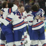Feb 22, 2026; Milan, Italy; Team USA players celebrate after a golden goal in overtime by Jack Hughes #86 of Team United States during the Milano Cortina 2026 Olympic Winter Games at Milano Santagiulia Ice Hockey Arena. Mandatory Credit: Geoff Burke-Imagn Images