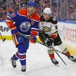 Mar 30, 2024; Edmonton, Alberta, CAN; Edmonton Oilers forward Connor McDavid (97) and forward Leo Carlsson (91) look for a loose puck during the third period at Rogers Place.