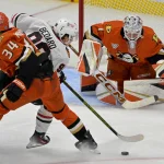 Nov 3, 2024; Anaheim, California, USA; Anaheim Ducks goaltender Lukas Dostal (1) gets set as defenseman Pavel Mintyukov (34) defends Chicago Blackhawks center Connor Bedard (98) from shooting the puck in the second period at Honda Center.