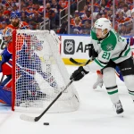 May 27, 2025; Edmonton, Alberta, CAN; Dallas Stars left wing Jason Robertson (21) skates with the puck behind Edmonton Oilers goaltender Stuart Skinner (74) during the second period in game four of the Western Conference Final of the 2025 Stanley Cup Playoffs at Rogers Place.